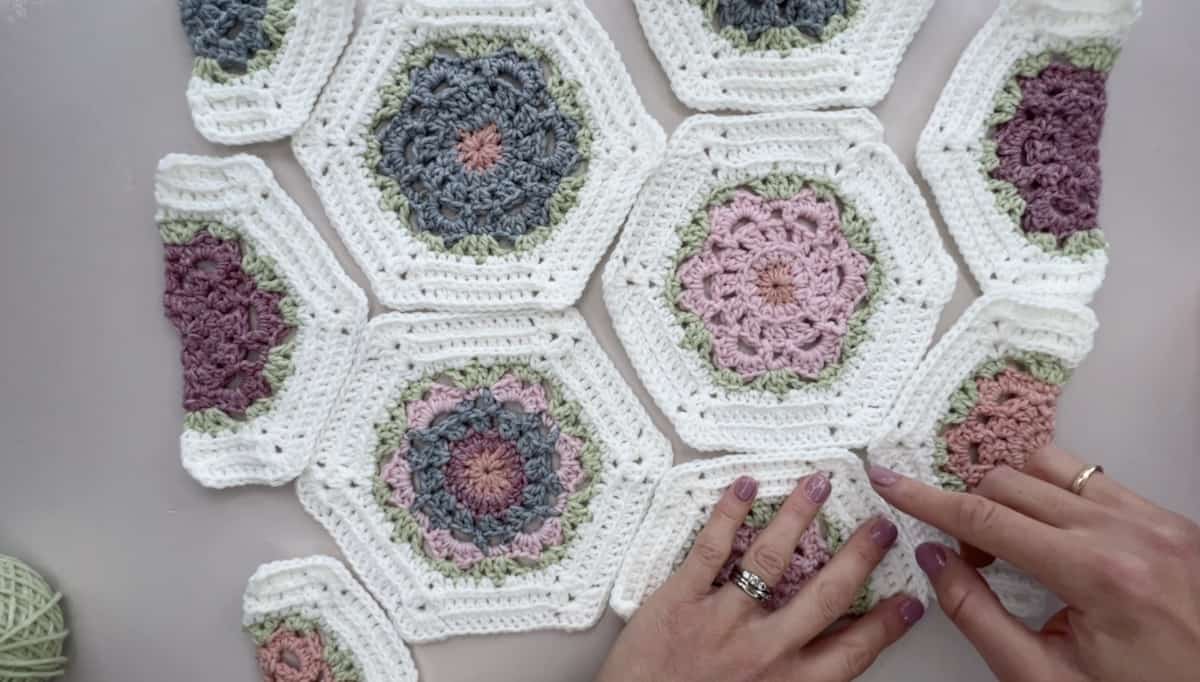 Crochet hexagons laid on a table ready to join together.
