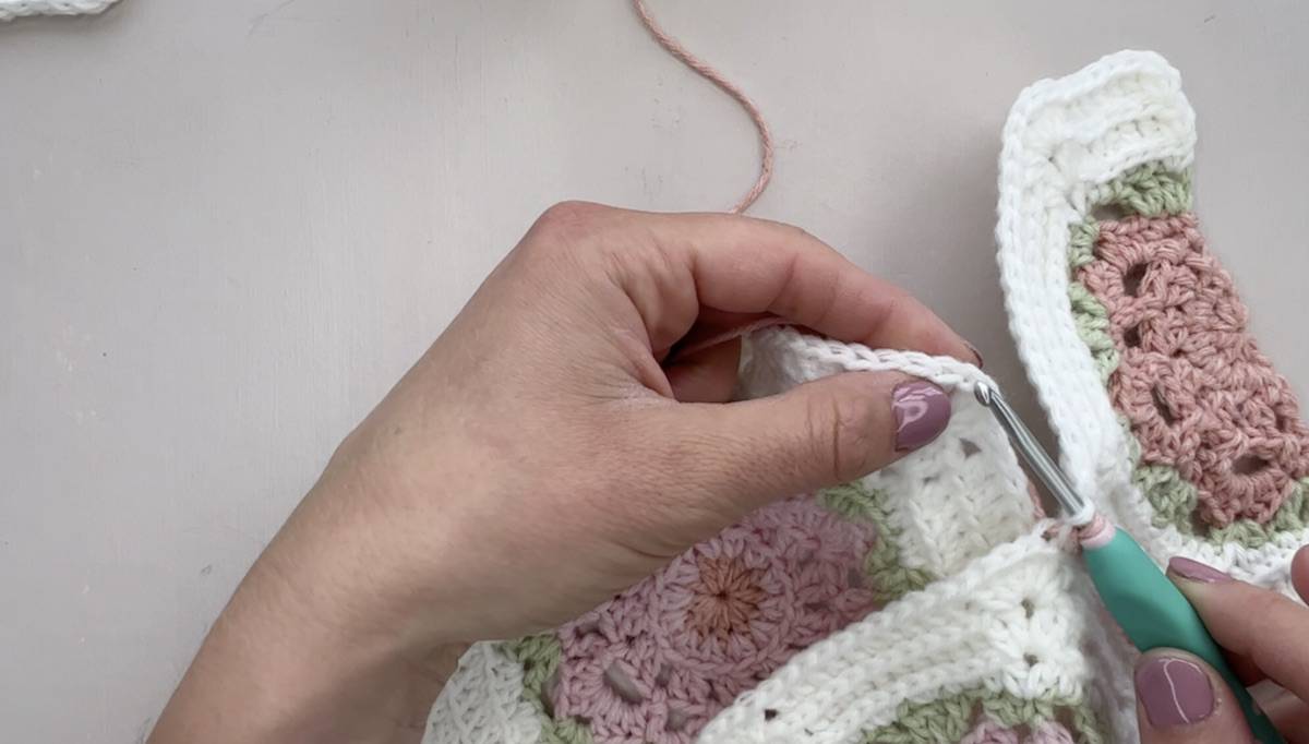 Adding another crochet hexagon to a blanket.