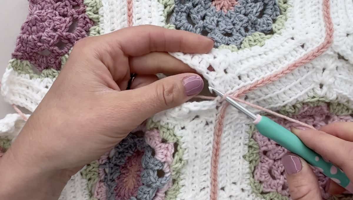 Final horizontal join of crochet hexagons.