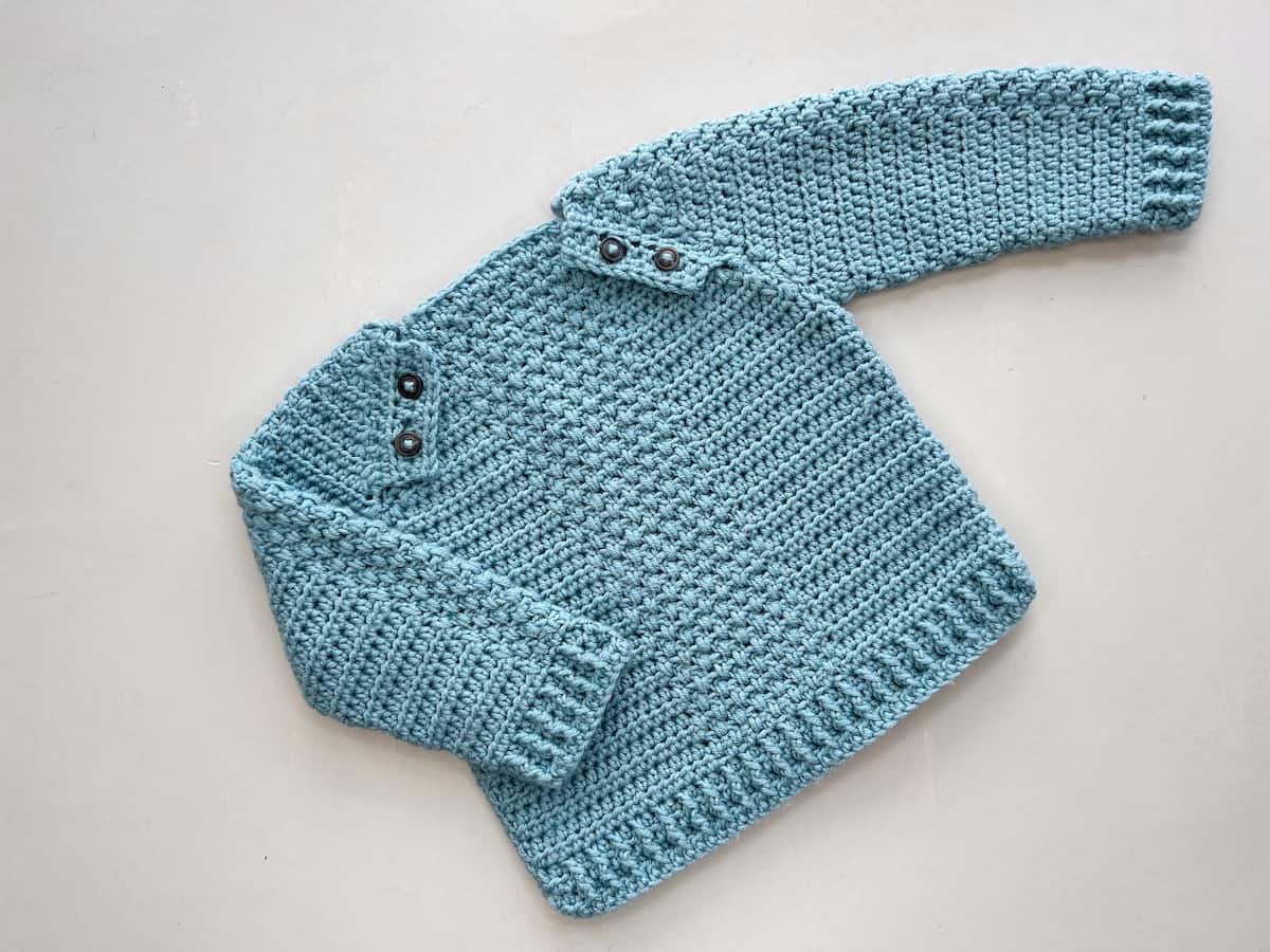 Simple baby crochet sweater pattern using textured stitches.