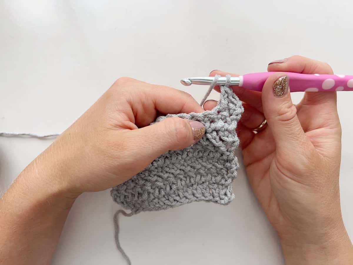 Herringbone double crochet stitch tutorial step 2 yarn over and insert hook into the stitch