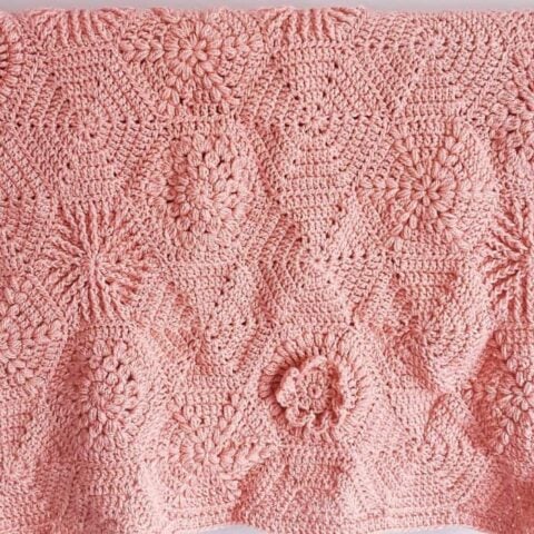 Pink crochet hexagon blanket.