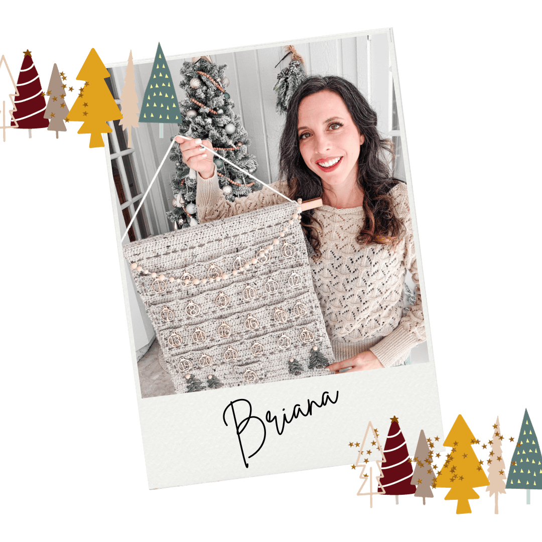 A woman is holding up a christmas calendar in front of a christmas tree.