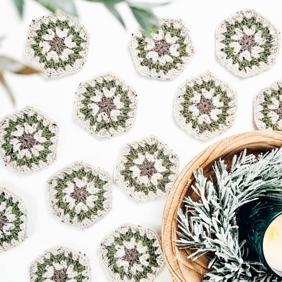 A basket with a candle and some crocheted coasters.