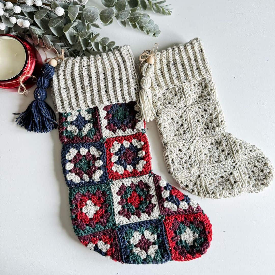 Two crocheted christmas stockings with tassels.