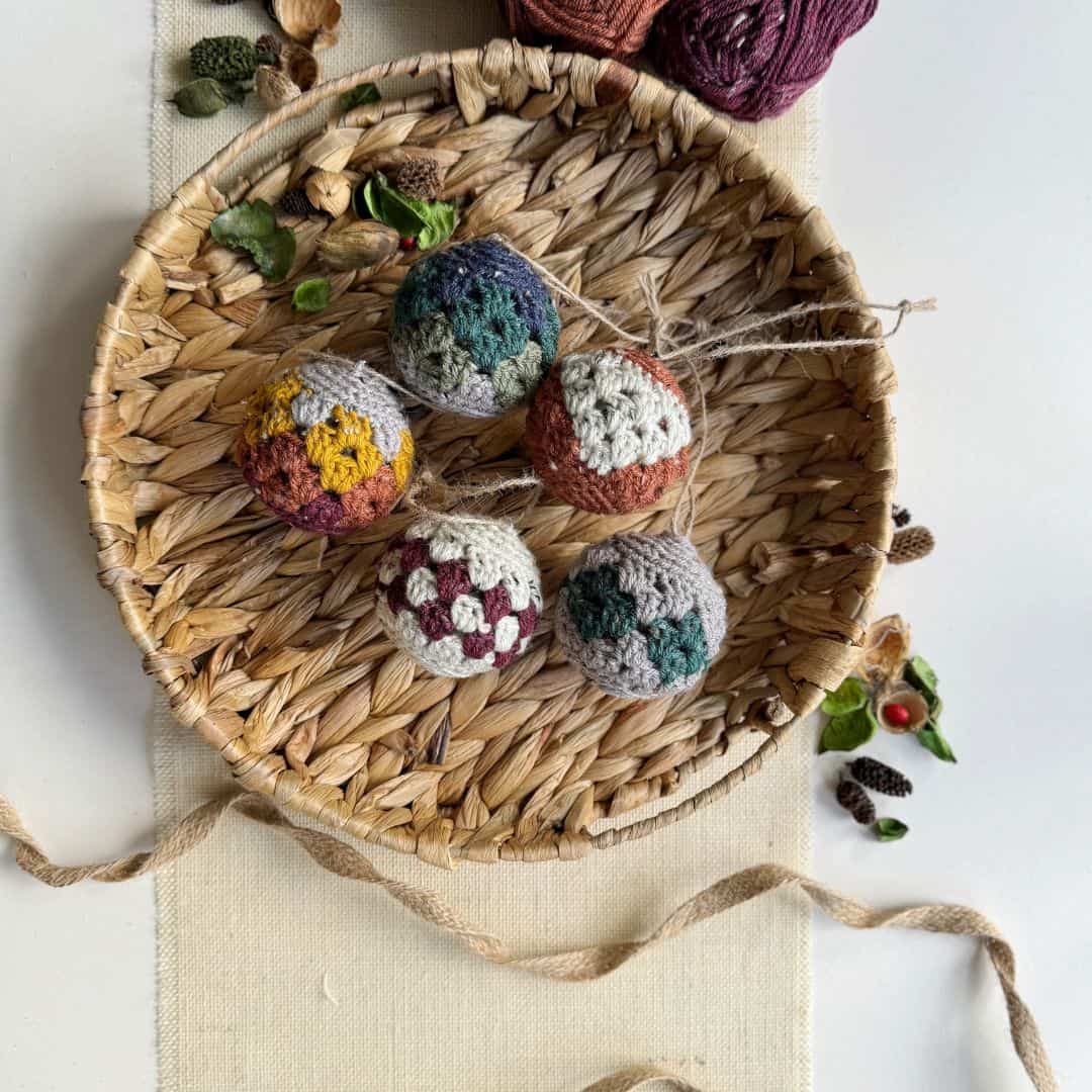Crocheted christmas ornaments in a basket.