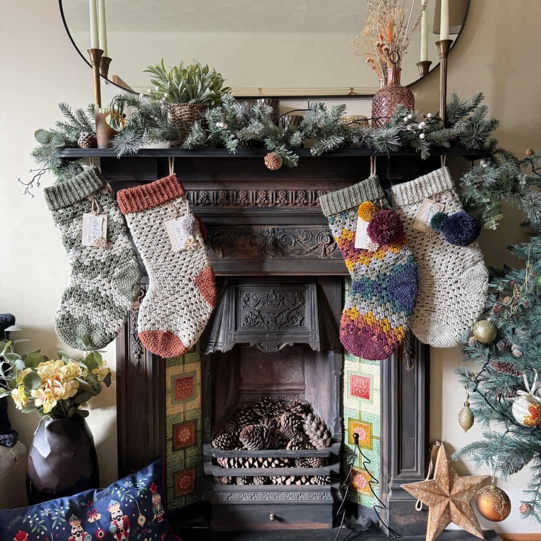 Christmas stockings hanging on a mantle in front of a fireplace.