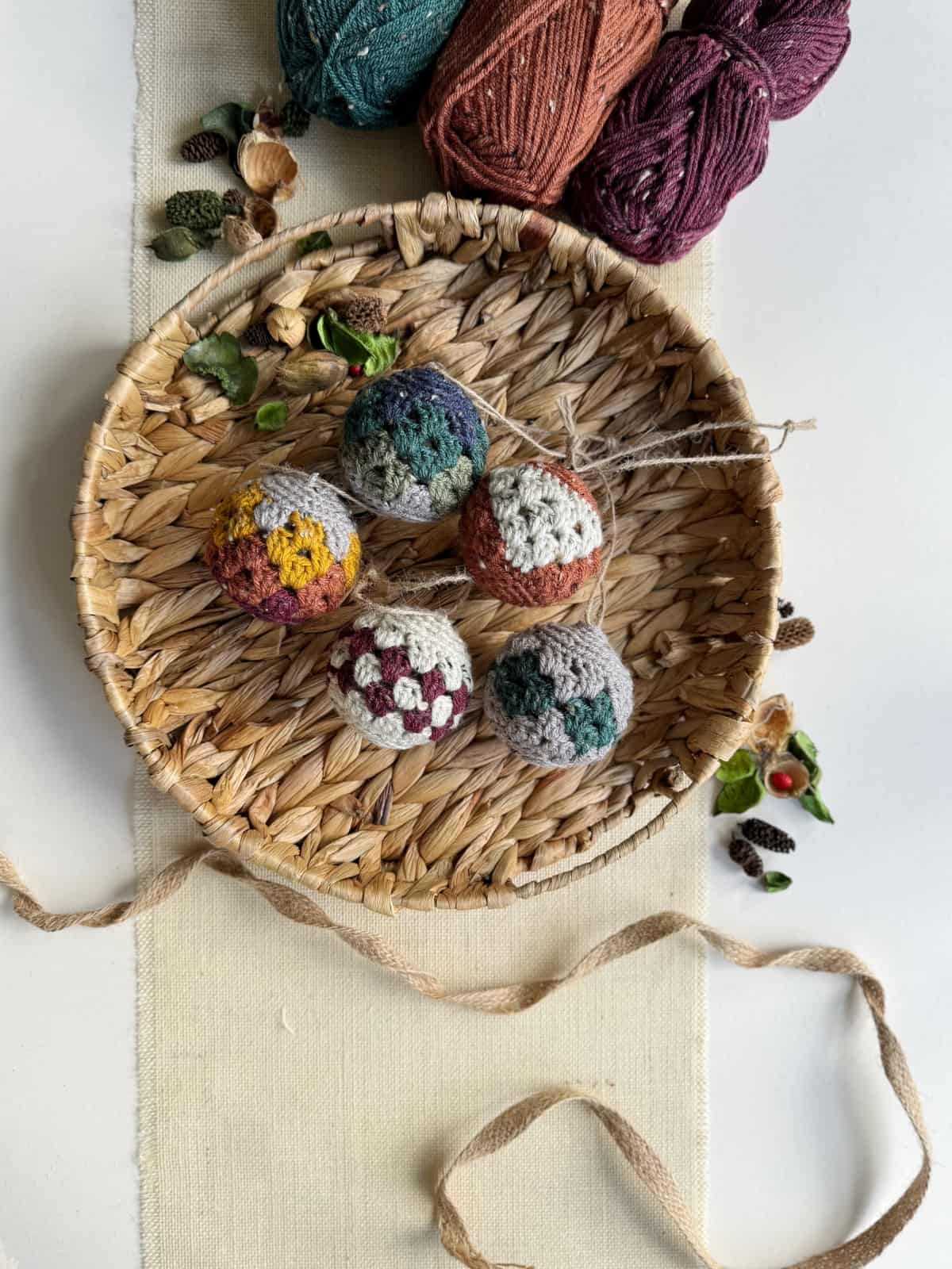 Crocheted balls in a basket on a table.