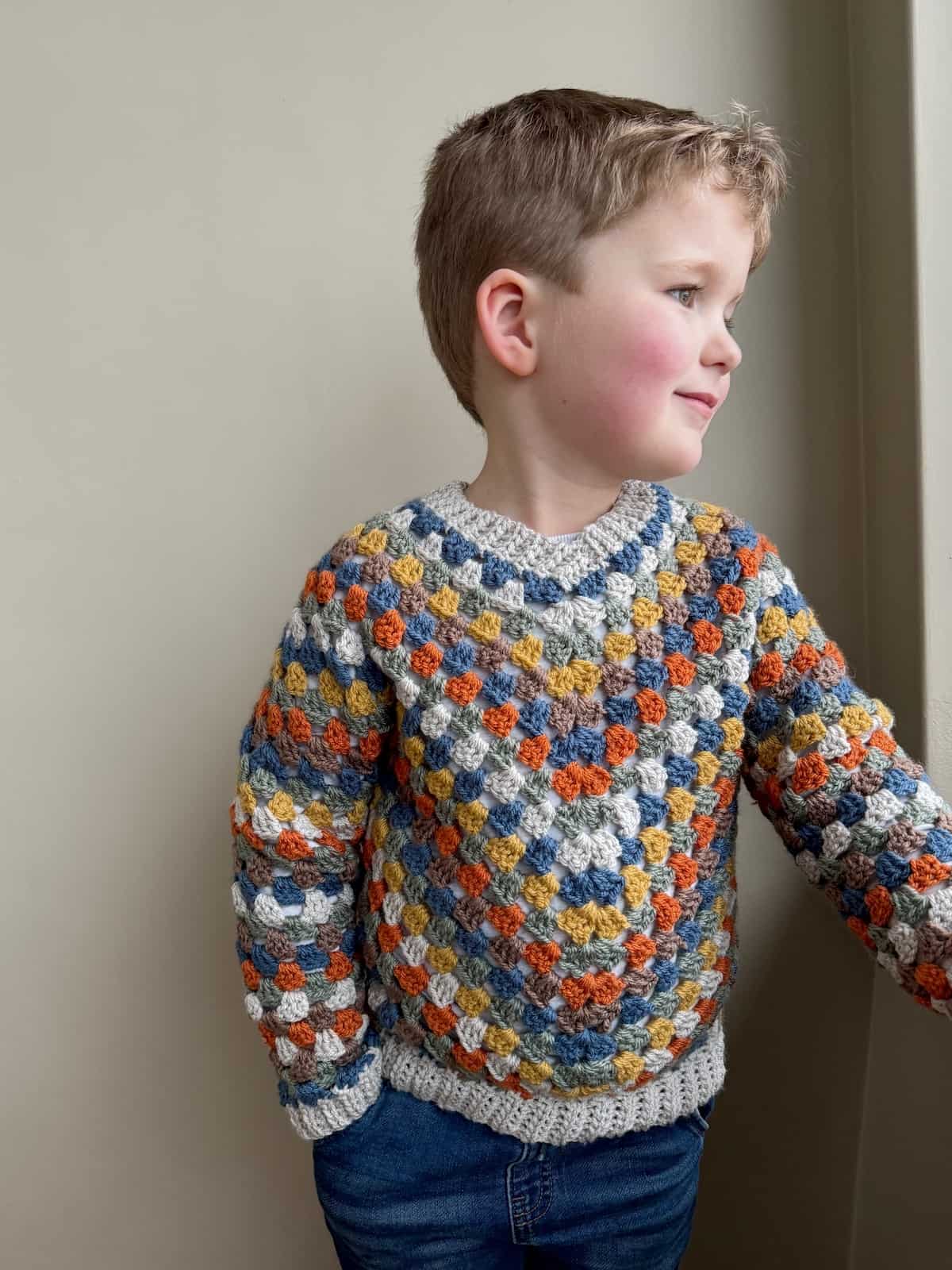 A child in a crocheted sweater.