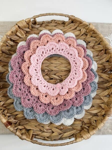 Crocheted doilies in a basket on a table.