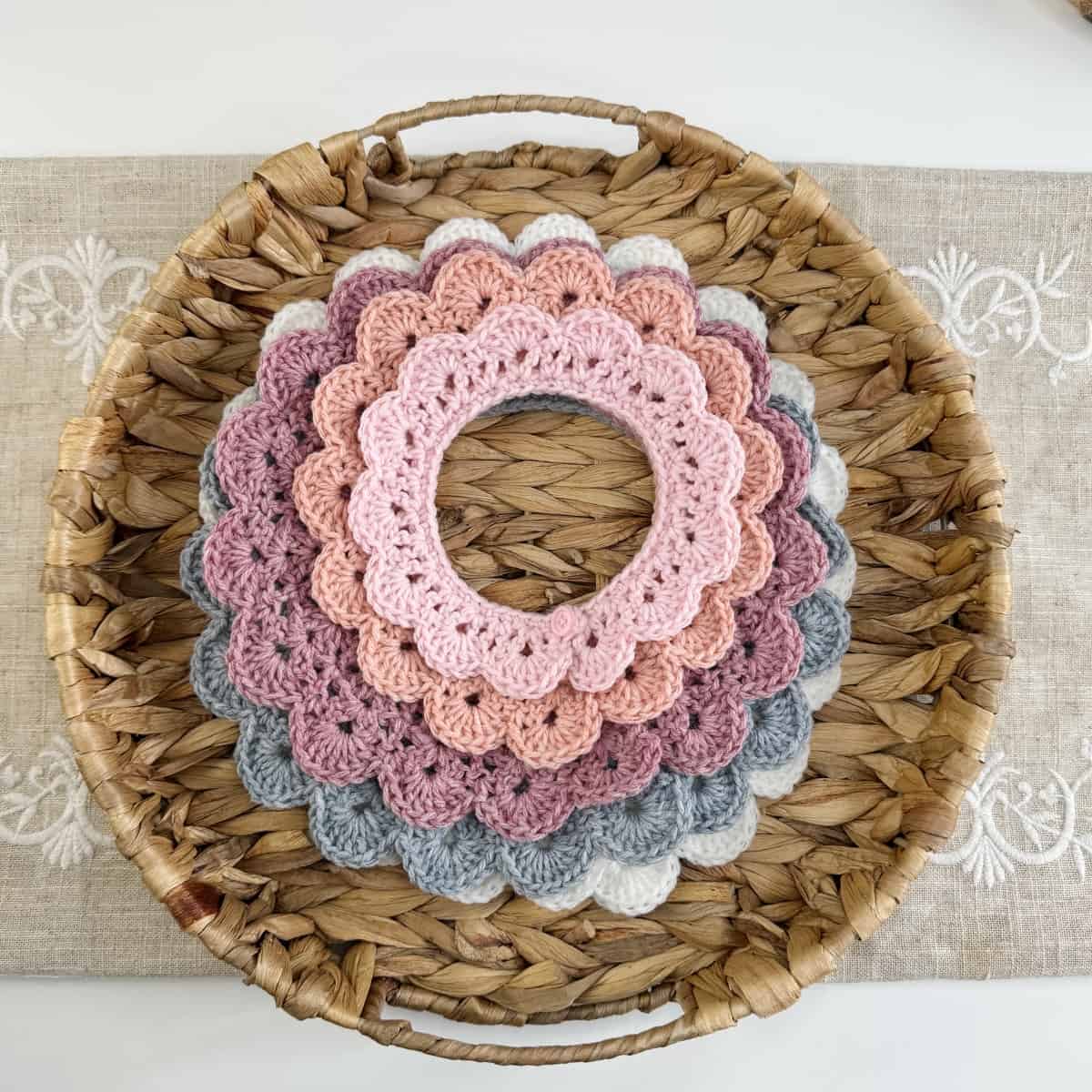 Crocheted doilies in a basket on a table.