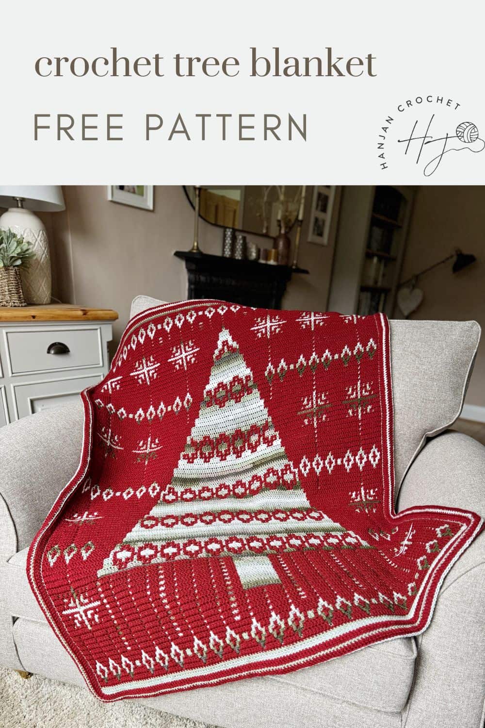 A red crochet tree blanket with festive white and green patterns is draped over a chair in a living room setting. Text reads "crochet Christmas blanket pattern, FREE PATTERN, Hannah Crochet.