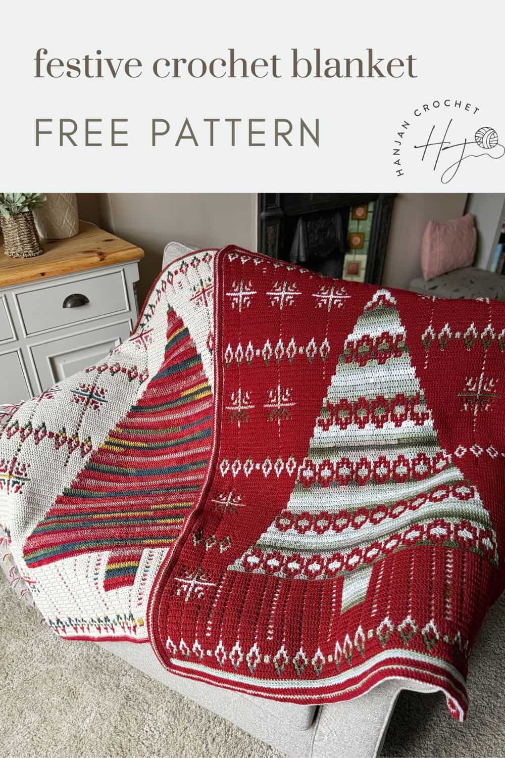 Red and white festive crochet Christmas blanket with striped and geometric patterns draped over a chair, next to a chest of drawers.