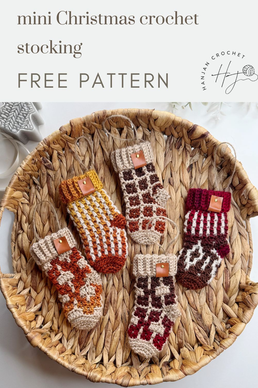 A woven basket holds five mini crochet Christmas stockings in various patterns and earth tones. Text above reads, "mini crochet Christmas stocking pattern FREE PATTERN.