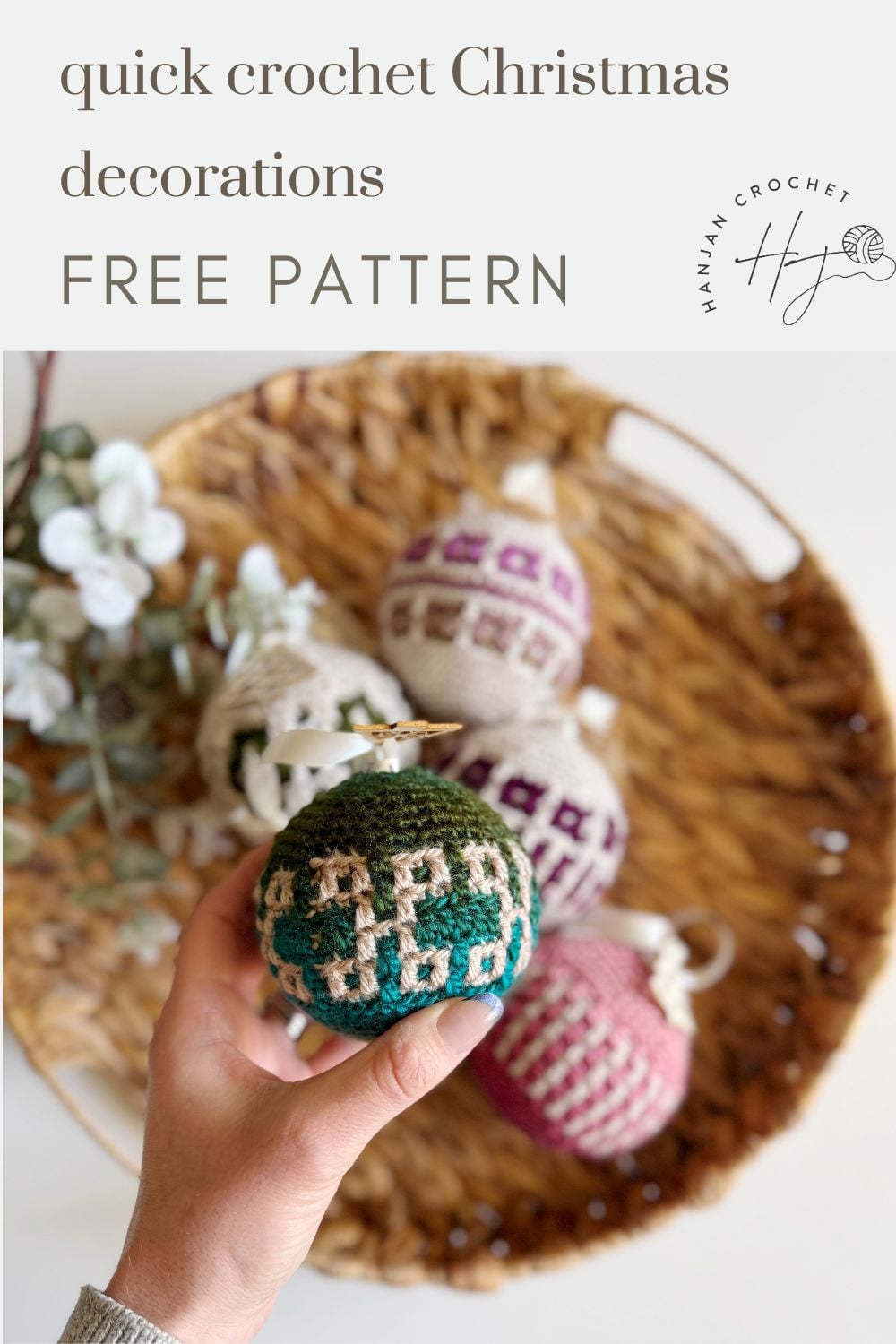 Hand holding a green and white crocheted Christmas ornament above a basket filled with crochet tree decorations and white flowers, with text offering a free pattern.