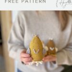 Person holding a crocheted yellow chick with white and gray details; text reads "amigurumi chick FREE PATTERN" with a crochet chicken pattern logo in the corner.