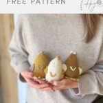 A person in a grey sweater holds three crocheted chicken figures in brown, cream, and yellow. Text above reads "cute crochet chicken FREE PATTERN"—perfect if you're looking for a fun crochet chicken pattern!.