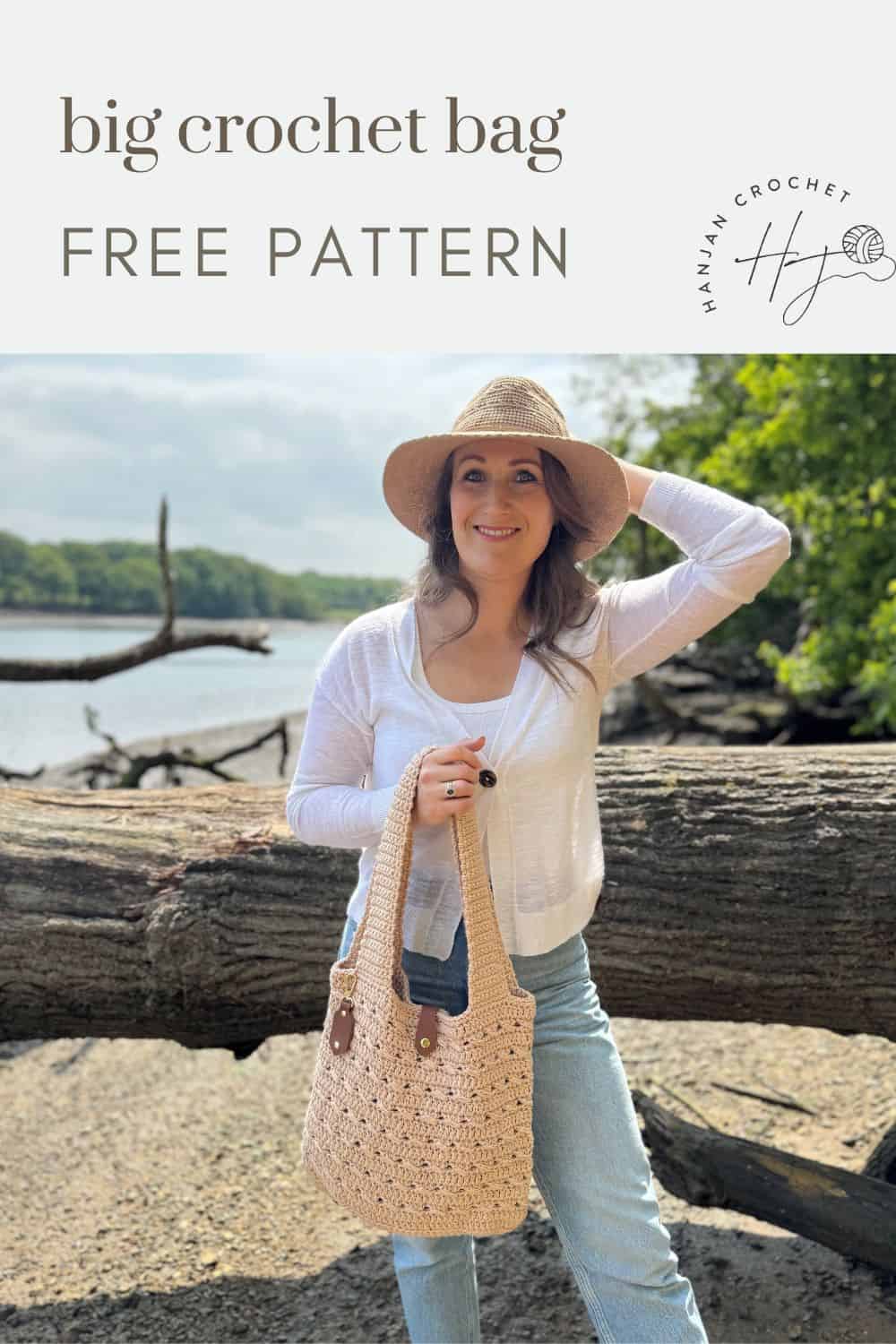 Woman wearing a straw hat and white top stands outdoors by water, holding a large crocheted bag; text above reads "big crochet bag FREE PATTERN." Discover this free crochet market bag pattern for your next stylish project.