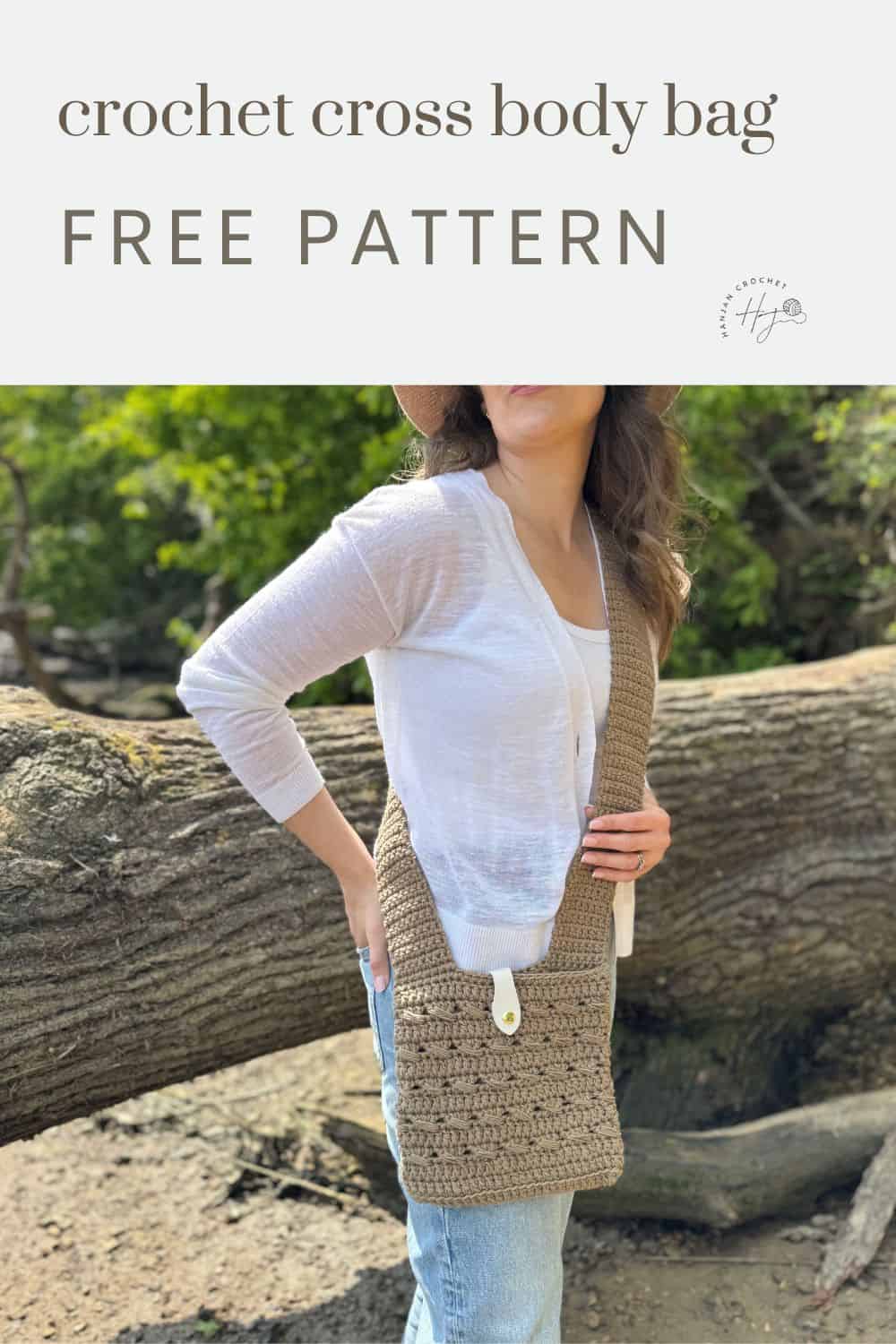 Woman wearing a crocheted crossbody bag with a button closure, standing outdoors by a fallen tree; text reads "crochet cross body bag free pattern" perfect for your next project.