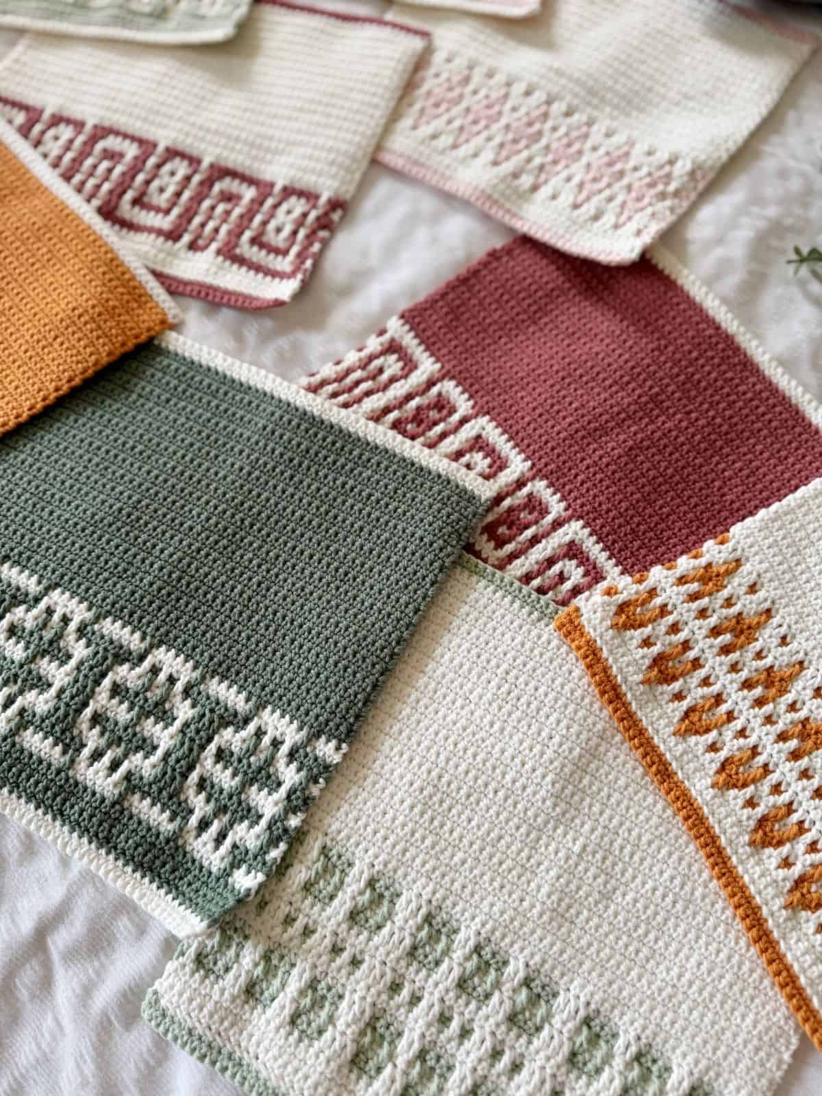 Several hand-crocheted swatches in various colors and geometric patterns, including an easy mosaic crochet pattern, are laid out on a white surface.