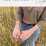 A person stands in a field wearing light pink, crocheted fingerless mittens with a cable pattern. Text above reads "crochet fingerless mittens pattern free—seamless and stylish!.