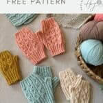 Four pairs of knitted hand warmers in pastel shades are displayed on a table with yarn balls and crochet pieces nearby. Text reads: "crochet fingerless mittens pattern free.