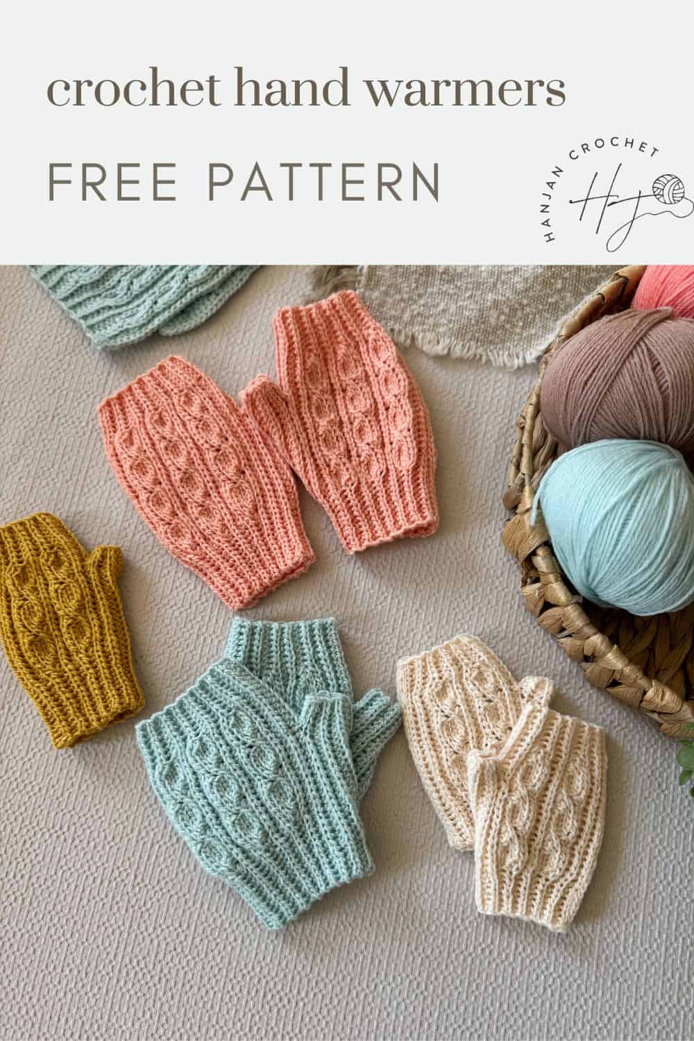 Four pairs of knitted hand warmers in pastel shades are displayed on a table with yarn balls and crochet pieces nearby. Text reads: "crochet fingerless mittens pattern free.