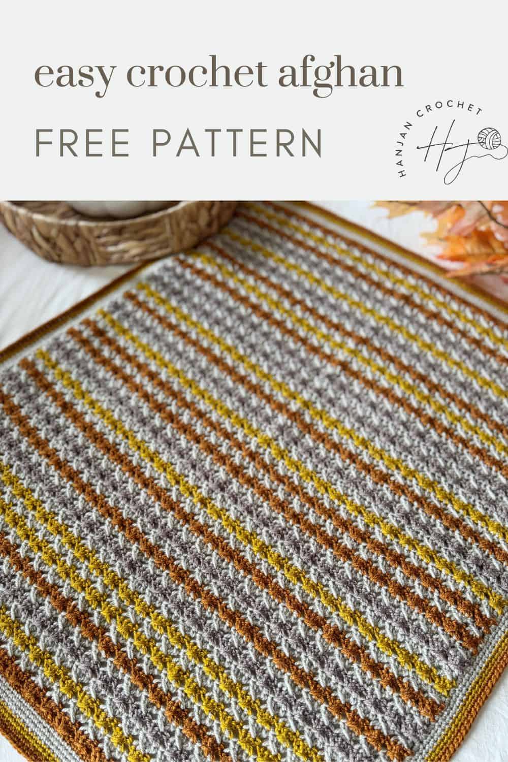 Rectangular crochet afghan featuring gray, brown, mustard, and white stripes with a textured stitch pattern, displayed flat on a surface. Text reads "easy crochet afghan free pattern"—a simple crochet blanket pattern for beginners.