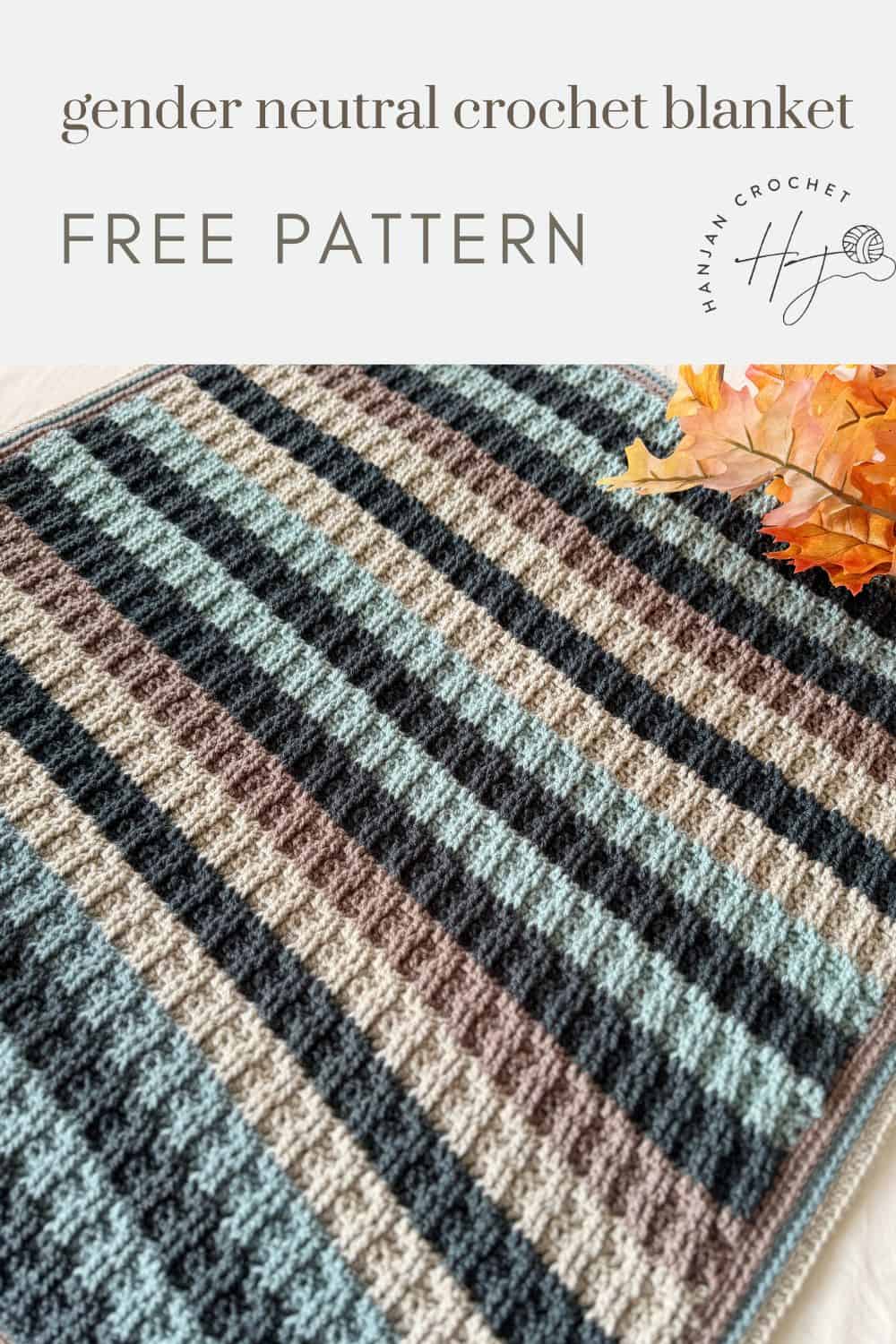 A striped crochet blanket for boys in muted blue, brown, and black tones is displayed with a sprig of autumn leaves. Text reads "gender neutral crochet blanket FREE PATTERN.
