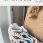 A person wearing white crochet gloves with colored patterns, inspired by a mosaic crochet mittens pattern, holds a mug. Text above reads "bottom up crochet gloves CROCHET PATTERN.