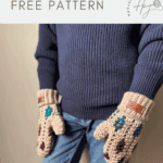 A person wearing a blue sweater and jeans models a pair of colorful mosaic crochet mittens. Text reads: "mosaic crochet mittens pattern FREE PATTERN.