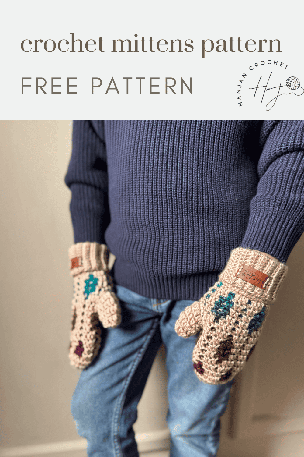 A person wearing a blue sweater and jeans models a pair of colorful mosaic crochet mittens. Text reads: "mosaic crochet mittens pattern FREE PATTERN.