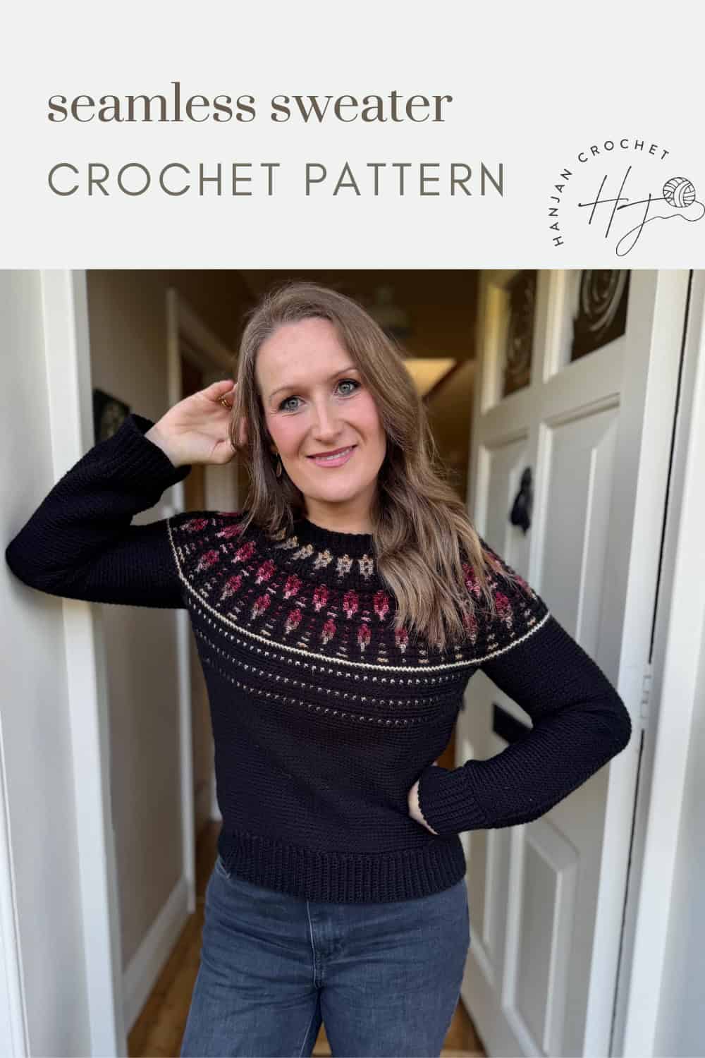Woman wearing a black sweater with a red and beige yoke design, standing in a hallway; text above reads “seamless mosaic crochet sweater pattern.”.