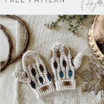 A pair of crocheted toddler mittens with multicolored accents is displayed on a textured fabric surface with decorative items nearby. Text reads "toddler mosaic crochet mittens pattern FREE PATTERN.
