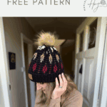 A woman wearing a black mosaic crochet beanie with a pom-pom stands in a hallway. Text above reads "unique crochet hat FREE PATTERN.
