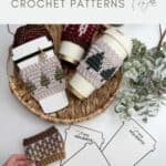 A wicker tray with crocheted holiday coffee sleeves on cups, yarn, greenery, and paper coffee cup templates labeled "Happy Holidays," featuring a festive Crochet Coffee Sleeve Pattern.