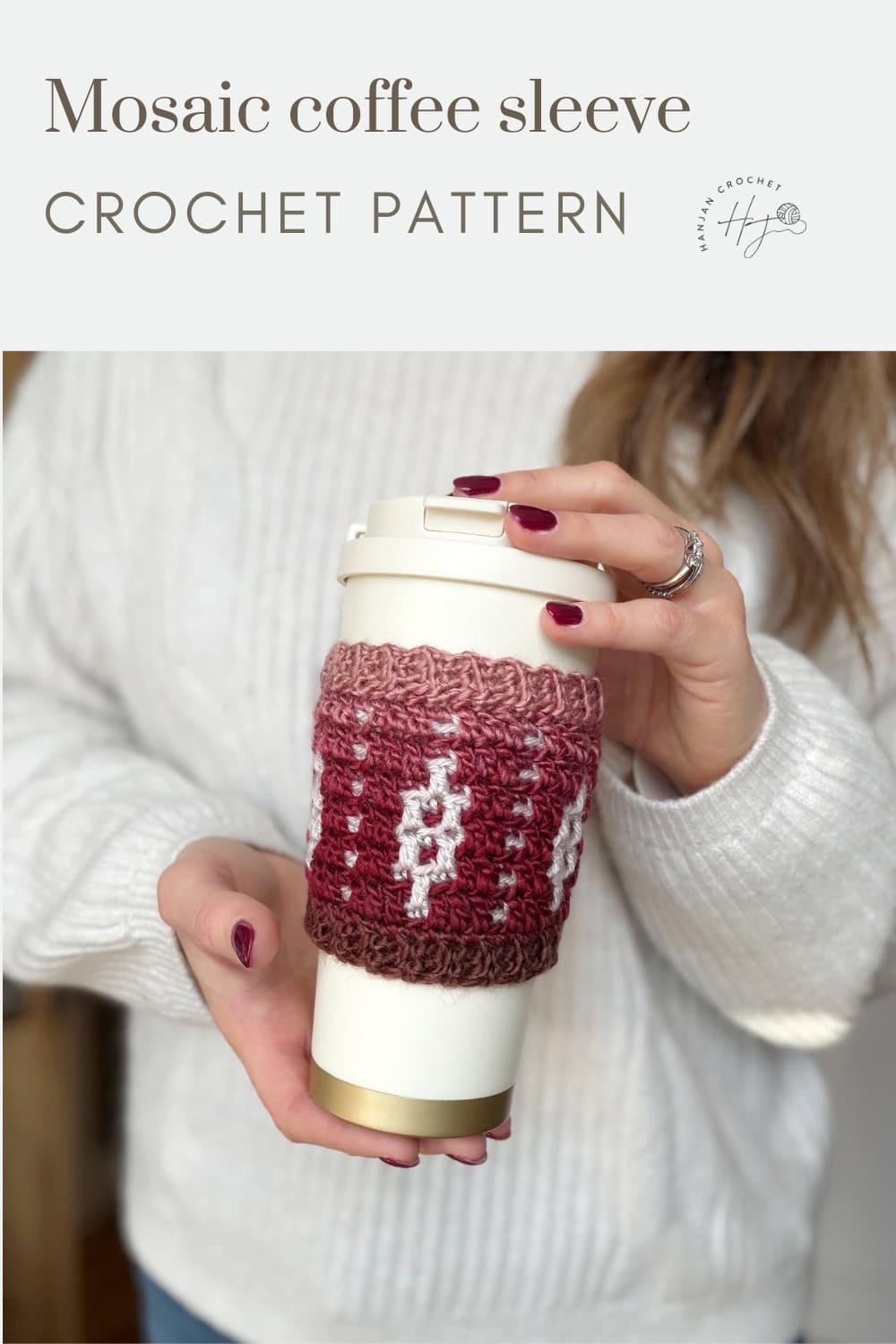 A person in a white sweater holds a to-go coffee cup wrapped in a red and white crocheted mosaic sleeve. Text reads "Crochet Coffee Sleeve Pattern—Mosaic Coffee Sleeve CROCHET PATTERN.
