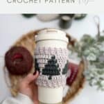 A hand holds a reusable cup with a crocheted sleeve featuring green tree shapes; text above reads "festive cup sleeve CROCHET COFFEE SLEEVE PATTERN.