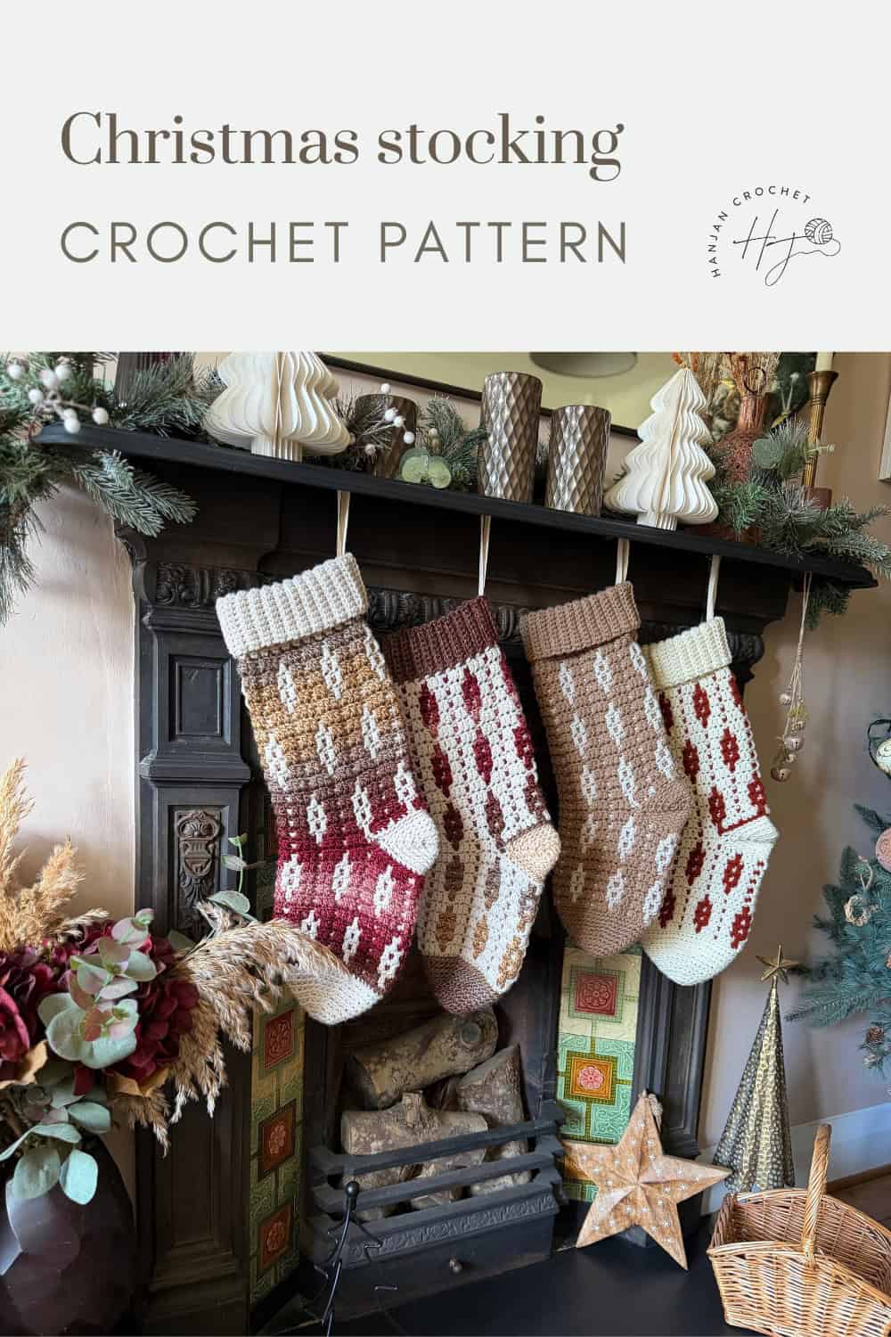 Four crocheted Christmas stockings in red, white, and brown tones hang from a decorated fireplace mantel with holiday ornaments and greenery.