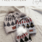Three crocheted Christmas hats, featuring tree and snowflake designs, each topped with a pom-pom, are displayed on a neutral fabric backgroundโperfect inspiration for your next christmas tree crochet hat pattern.