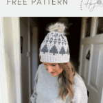 Woman wearing a gray and white crochet hat with a pom-pom stands indoors; text above reads "Christmas tree crochet hat pattern FREE PATTERN" with a crochet logo.
