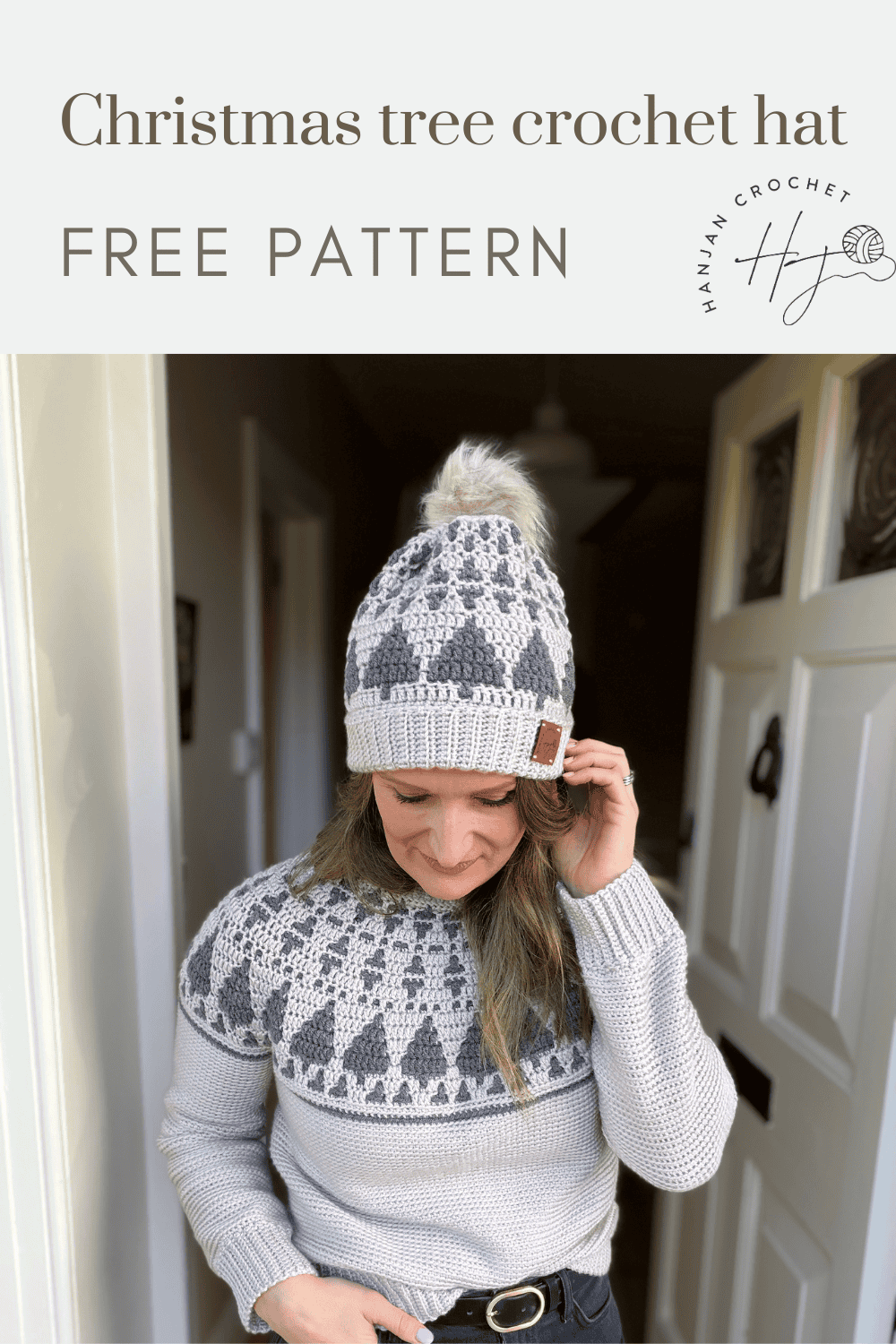 A woman stands in a doorway wearing a matching crocheted hat and sweater, both featuring a festive Christmas tree pattern; text reads "Christmas tree crochet hat pattern FREE PATTERN.