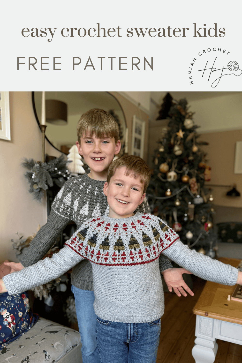 Two smiling children wearing handmade crochet Christmas sweaters stand in a festive living room, with a tree and ornaments in the background. Text reads "easy crochet sweater kids FREE PATTERN.