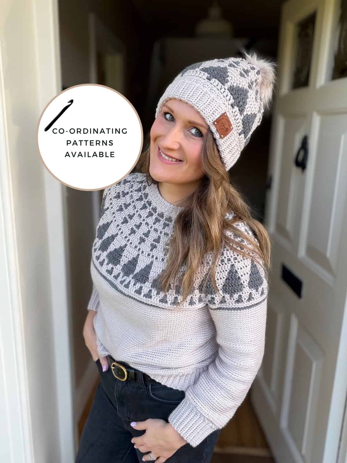 Woman wearing a crochet Christmas sweater pattern and matching knit hat with a geometric design, standing in a doorway. Circular graphic reads "Co-ordinating patterns available.