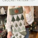 A person holds a crocheted Christmas stocking with green trees and a ribbed green cuff, beautifully displaying a classic crochet stocking pattern.