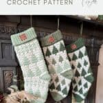 Three Christmas stockings, crafted using a festive crochet stocking pattern with green and white tree designs, hang from a cozy fireplace mantel.
