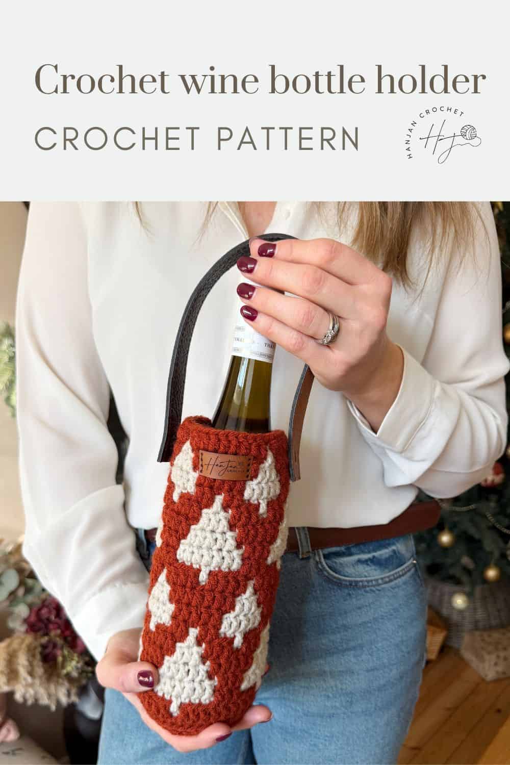 A person holds a wine bottle in a red and white crochet wine bottle holder with a handle. The text reads "Crochet wine bottle holder crochet pattern.