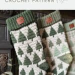 Two crocheted Christmas stockings with green tree patterns hang side by side, showcasing a modern crochet stocking pattern.
