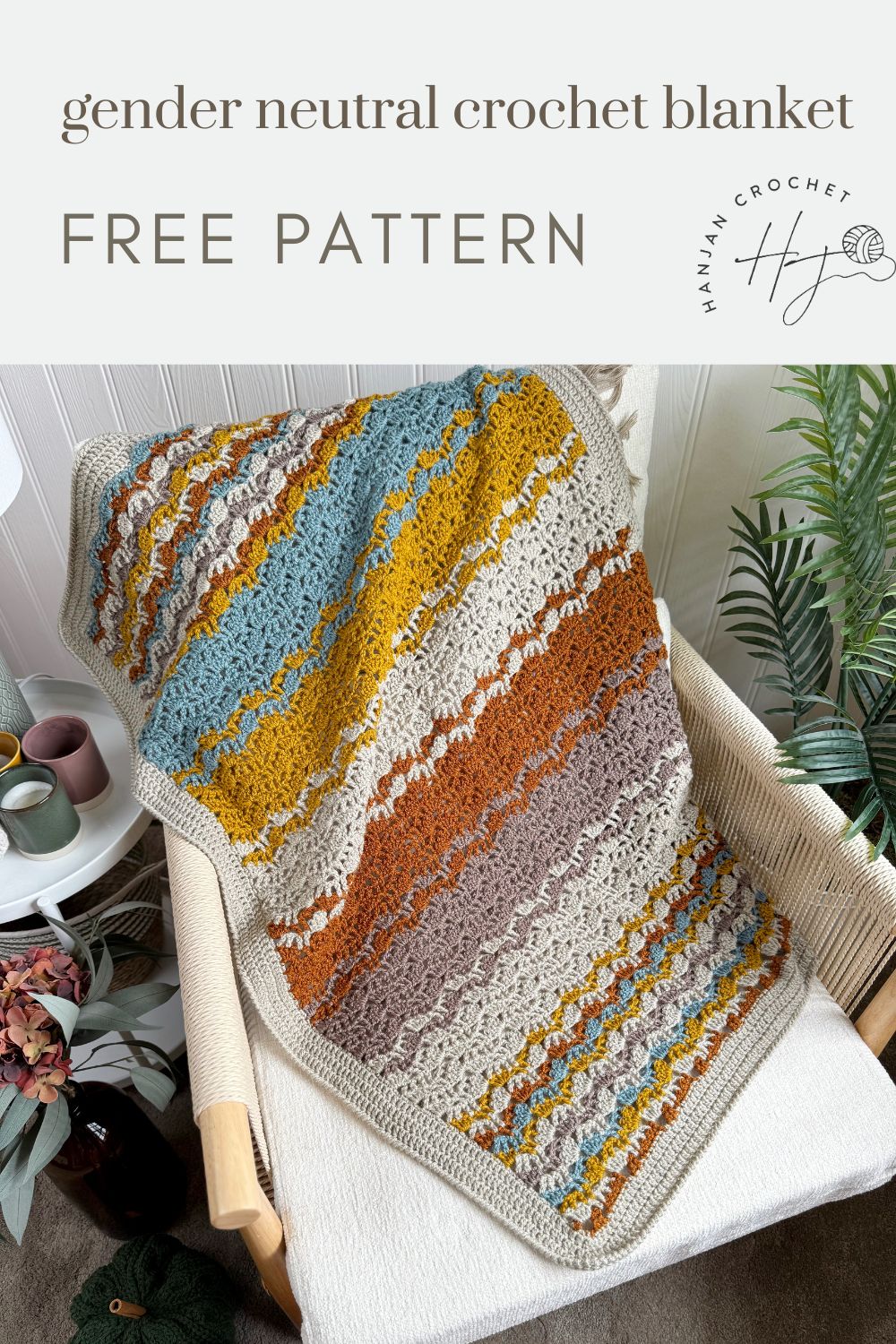 A multicolored, lacy crochet blanket with textured patterns draped over a chair, next to potted plants; text reads "gender neutral crochet blanket free pattern.