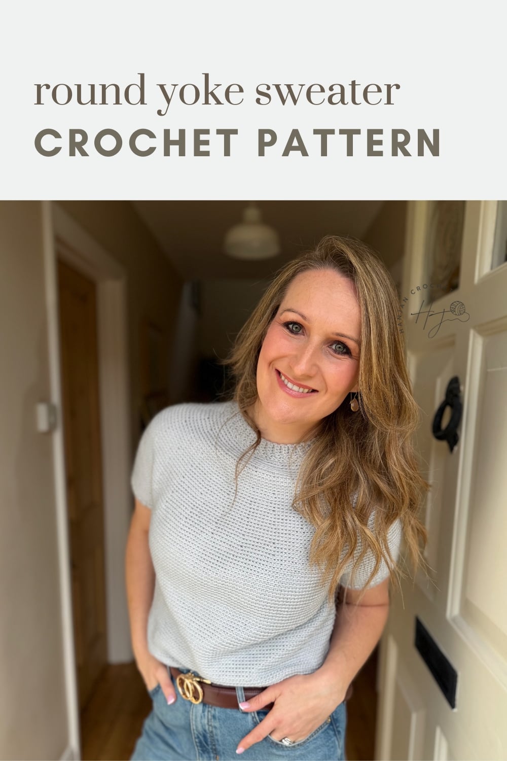A woman wearing a light gray round yoke crochet sweater stands indoors, smiling at the camera. Text above reads "round yoke sweater CROCHET PATTERN.